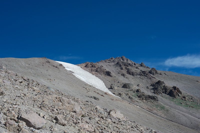 Snow clings to the mountain around the peak late into the summer.