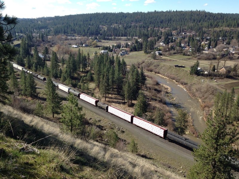 Valley below High Drive, with views of the river and train passing through.