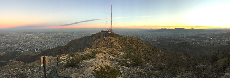 A panoramic view from the top of Directissimo. Ranger Peak Loop continues ahead towards the top of the Wyler Aerial Tramway, in the center of the picture. The southern suburbs of El Paso are visible beyond the mountains. Ciudad Juarez and the Sierra Madre range extend off into the distance.