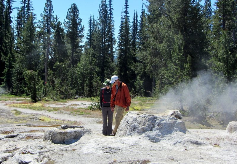 Union Geyser, with its three conspicuous cones, lies on the south end of the basin. Though its eruptions are rare, an occasional backpacker is treated to a spectacular sight. All three cones erupt simultaneously. The center cone sometimes reaches a height of over 100 feet.