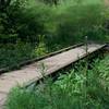 The bridge crossing the small creek that runs through the ravine.