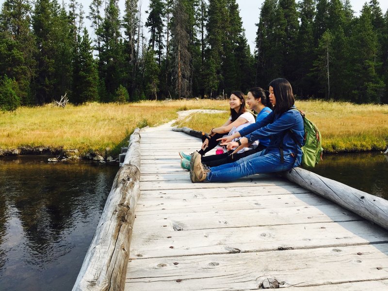 Resting on a boardwalk along the Shoshone Lake Trail.