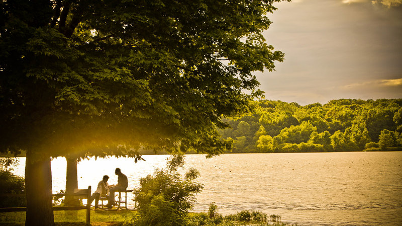 Visitors enjoy a golden evening at Eagle Creek Park.