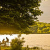 Visitors enjoy a golden evening at Eagle Creek Park.