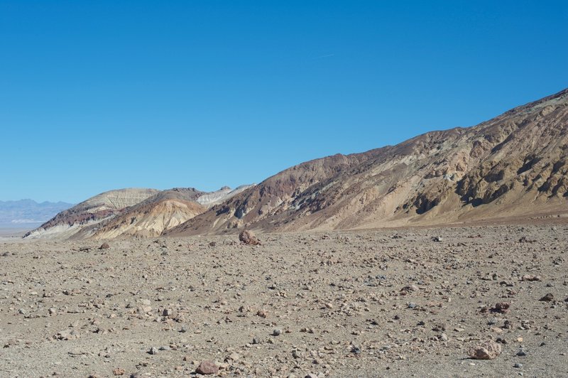 The canyon walls start to rise above you as the different colored rocks indicate different geological types.