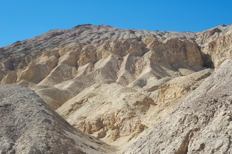 The landscape has been shaped by wind and water over the years. The canyon starts to creep in on the trail at this point.