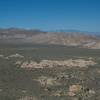 Rock formations and Joshua Trees spread out before you as the trail climbs the mountain.