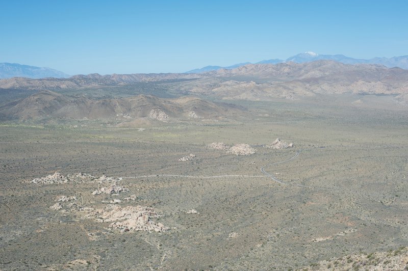 The road to Keys View snakes its way through the park and piles of boulders. Joshua Trees spread throughout the area.