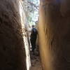 Hiking between rocks on the Petroglyph Point Trail.