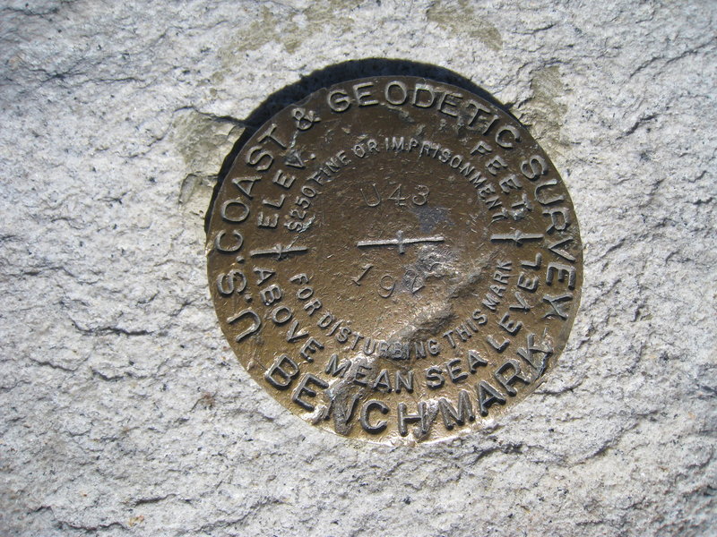 An iconic USGS marker awaits those who summit Mt. Whitney