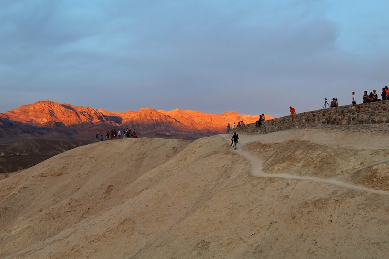 The mountains glow orange in the sunset near Zabriskie Point.