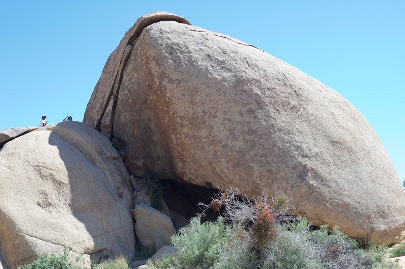 A large cave can be seen under the split rock at the trailhead.