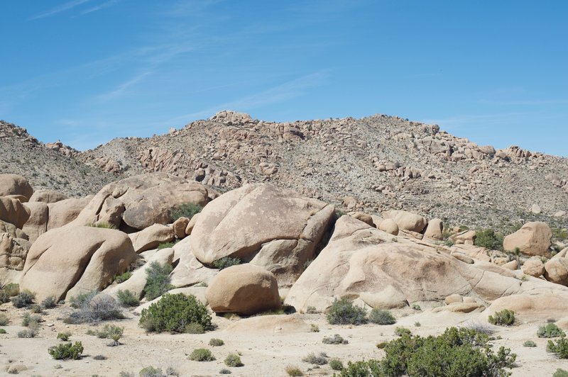 Rocks and the surrounding hills spread out before you.