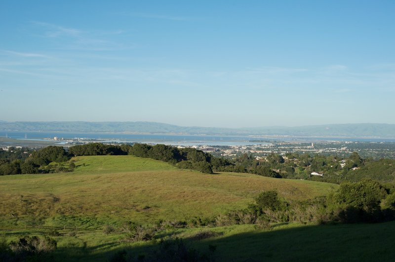 The trail begins to emerge from the woods and views of the San Francisco Bay area stretch before you.