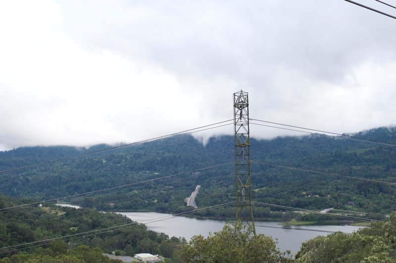 Views of Lexington Reservoir and Highway 17 are obscured by power lines that cut through the open space.