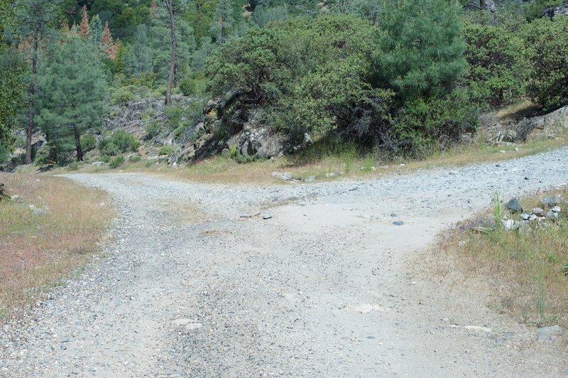 The trail goes straight as a road breaks off to the right and leads to the dam, which is off limit to civilians.