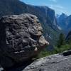 A glacial erratic with El Capitan and Half Dome in the background.