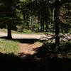 The trail continues on the other side of this road that leads to the gravel pit.