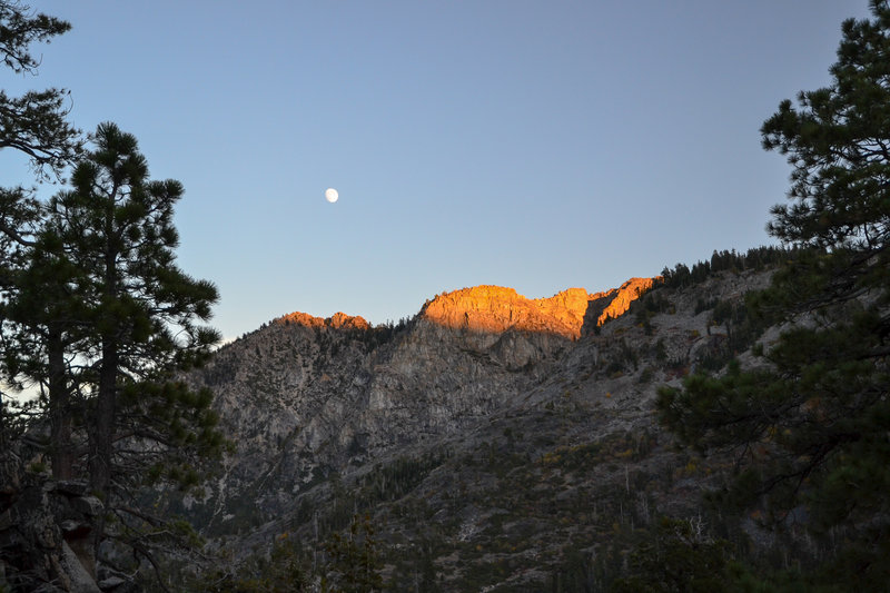 The moon rising over the nearby mountains.