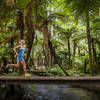 A runner crosses a bridge along Puarenga Stream.