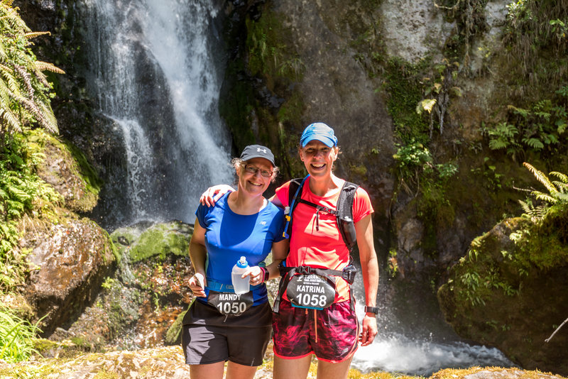 Runners stop below Wairere Falls Buried Village.