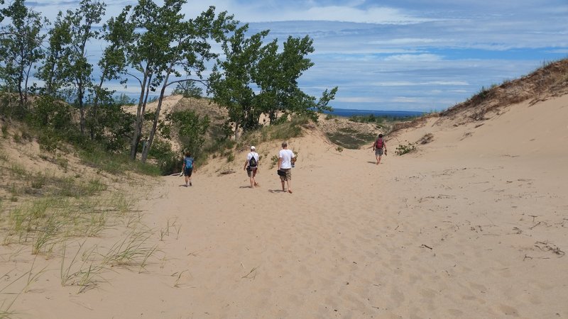 Hiking over sand to Lake Michigan