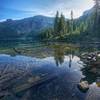 Stunning reflection on the very still Mowich Lake as the sun rises alongside the Wonderland Trail.