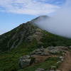 The summit of Mt. Lafayette looms out of the clouds ahead.