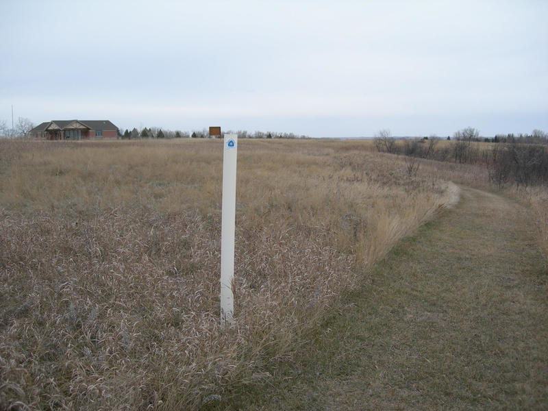 The white posts with the white/blue triangle mark the North Country Trail. For westbound NCT travelers, this is the end.