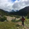 A climber ascends above Glacier Basin towards the Inter Glacier on a primitive climbers trail.