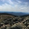 View from the summit, summit sign marker to the right of the photo.