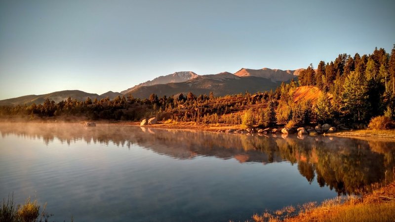 Pike's Peak reflects off of the placid water in the early morning light.