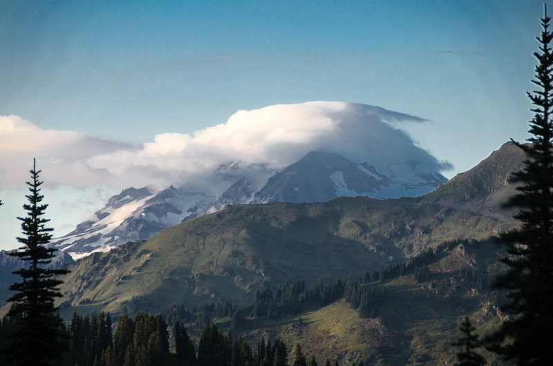 View of Glacier Peak wrapped in clouds from Cady Ridge.