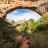 Hiking beneath Sipapu Bridge. Photo Credit: NPS Photo / Jacob W. Frank.