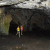 Through one of the numerous caves.