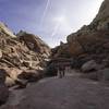 Looking up at the massive rocks surrounding the trail.