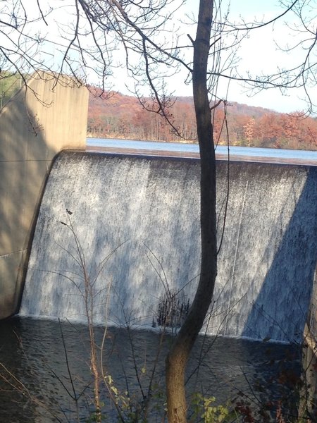 The "waterfall" dam overflow. A bench is available to take in the sight.