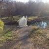 Metal foot bridge over Muddy Creek along North Country Trail.