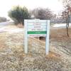 The Stanley Draper MTB Trails Open / Closed sign located at the trailhead parking lot. The trail will be closed during wet conditions by the Oklahoma Earthbike Fellowship to prevent trail damage.