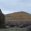 A large, yellow, clay hill can be seen off in the distance.  The colors are amazing and represent the different climate variations in different eras.