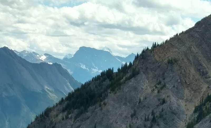 A zoomed-in view to the south displays Mount Assiniboine in the distant center.