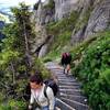 Climbing the final staircase switchbacks toward the ladder.