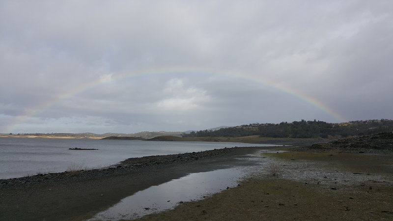 A lucky rainbow over Folsom Lake appears during a winter storm.