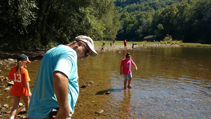 Hikers enjoy the boat launch area in the summer heat at the Blue Heron Outdoor Museum along the Blue Heron Loop Trail.