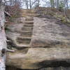 A carved-rock staircase leads to the top of Double Arch.