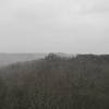 Courthouse Rock looms from the top of Double Arch in some windy snow flurries.