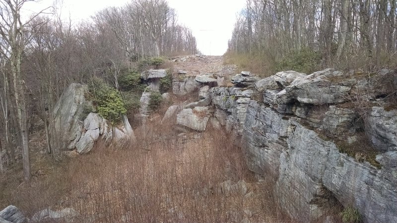 The cliffs follow alongside the Raven Rock Trail near its end.