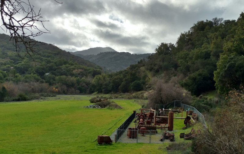 The Hacienda Entrance to Quicksilver Park features the site of the old Hacienda Furnace and Reduction Works. In the lower right, a display of old mining machinery greets visitors to the park.