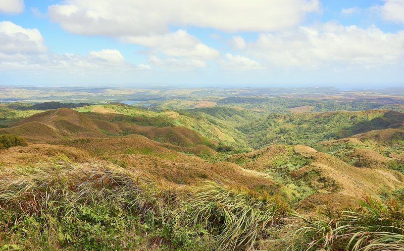 The view to the north depicts lush, rolling grasslands.