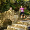 Runners navigate The Bridge of Love in Episkopeio Village.